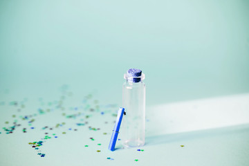 A small glass jar with a scroll for desires, sequins, magic.