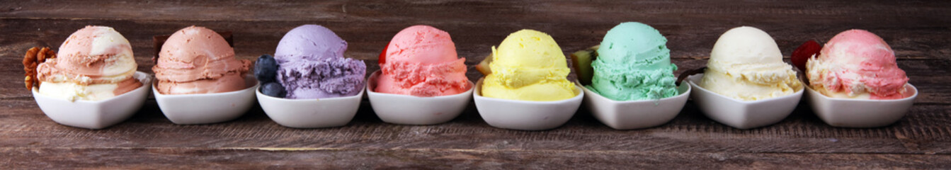 Various of ice cream flavor whit fresh blueberry, strawberry, kiwi, lemon, vanilla setup on rustic background . Summer and Sweet cold ice cream