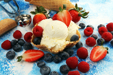 Vanilla ice cream scoops with fresh berries. Strawberries, raspberries with ice cream
