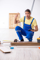 Young male contractor working indoors