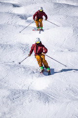 People are enjoying mogul skiing snow boarding	