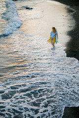 girl in the sea with a surf