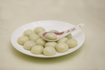 A plate of yuanxiao is on the table