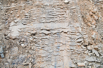 View of brown cracked natural moist earth clay. The background. Texture