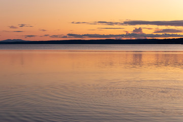 calm clean water of the puget sound with colorful sunset