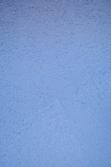 Wall of blue rough embossed building decorative stucco. Texture, background