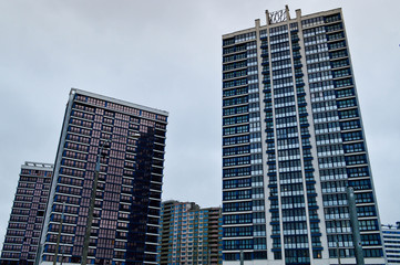 Obraz premium New modern tall blue glass multi-storey comfortable urban monolithic frame houses buildings skyscrapers new buildings in the big city of the megalopolis