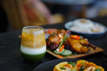 Fresh green iced milk tea is a companion drink for a spicy lunch.