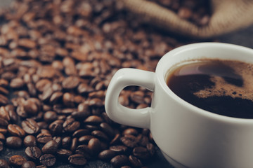 Ground coffee and coffee beans on old cafe table.
