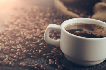 Ground coffee and coffee beans on old cafe table.
