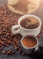 Ground coffee and coffee beans on old cafe table.