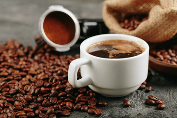 Ground coffee and coffee beans on old cafe table.