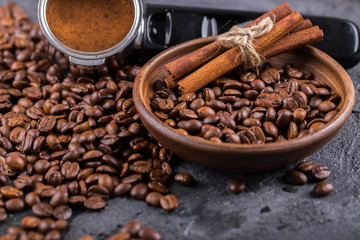 Ground coffee and coffee beans on old cafe table.