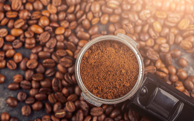 Ground coffee and coffee beans on old cafe table.