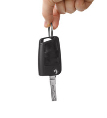 Man holding key on white background, closeup. Car buying