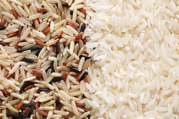 Brown and polished rice as background, top view