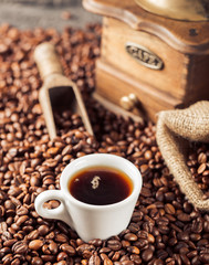 Ground coffee and coffee beans on old cafe table.