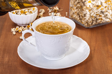 pouring chamomile tea with press teapot