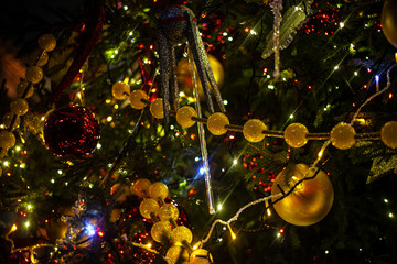 Fototapeta na wymiar Christmas background. Christmas tree decoration. Beautiful bright garlands. Festive texture. Decor Elements. Toys hang on a Christmas tree. The feeling of Christmas.