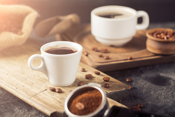 Ground coffee and coffee beans on old cafe table.