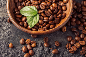 Ground coffee and coffee beans on old cafe table.