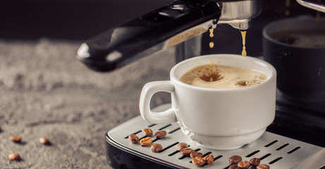 Ground coffee and coffee beans on old cafe table.