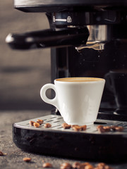 Ground coffee and coffee beans on old cafe table.
