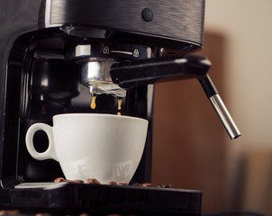 Ground coffee and coffee beans on old cafe table.