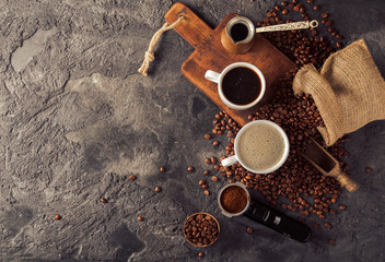 Ground coffee and coffee beans on old cafe table.