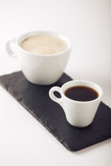 Ground coffee and coffee beans on white background