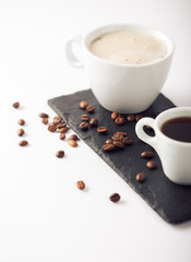 Ground coffee and coffee beans on white background