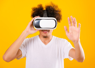 Asian handsome man with curly hair he using virtual reality headset or VR glass