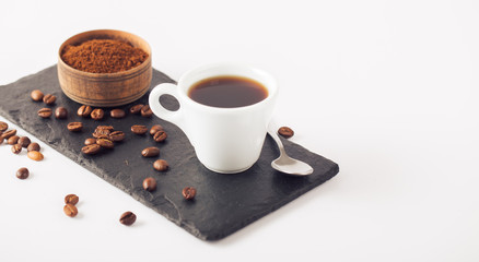 Ground coffee and coffee beans on white background