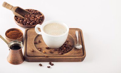 Ground coffee and coffee beans on white background