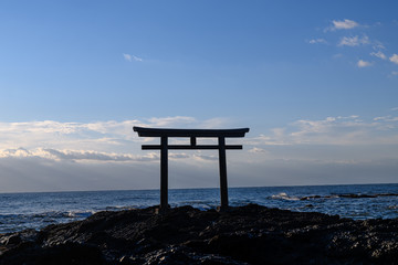 Oarai Japanese white shinto torii gate in the sea