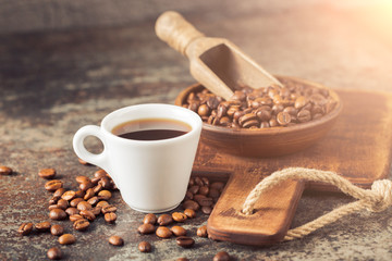 Ground coffee and coffee beans on old cafe table.