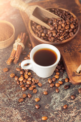 Ground coffee and coffee beans on old cafe table.