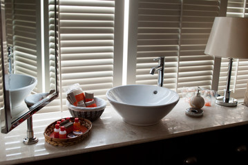 Bathroom in the hotel room: overhead sink and bath accessories