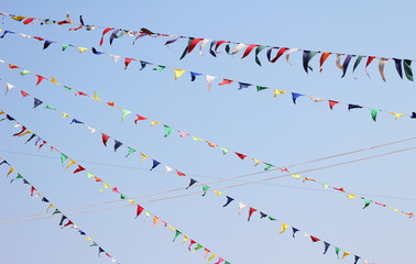 colorful triangle party flags on sky background for decoration