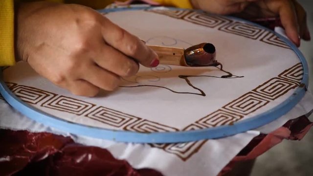 Hand painting traditional batik in the workshop