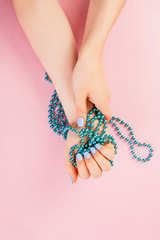 Stylish trendy female manicure. Beautiful young woman's hands on pink background. Minimalist manicure trend. Top view, flat lay. Copy space for text.