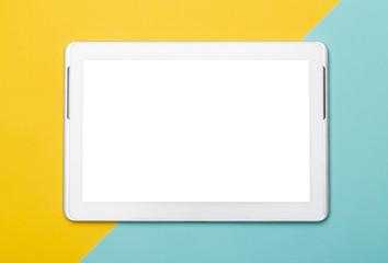 White tablet computer with blank screen mockup isolated on yellow and blue background. Clipping path.