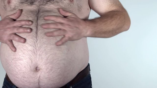Funny fat man showing his big belly.