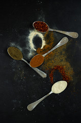 spilled spices on a black background
