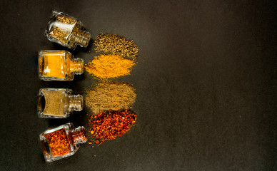 spilled spices on a black background