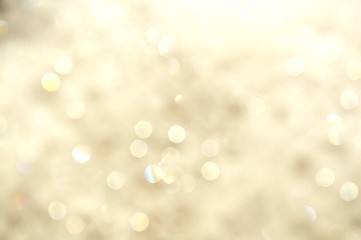The abstract bokeh of a dishwashing liquid sponge that reflects in the sunlight.