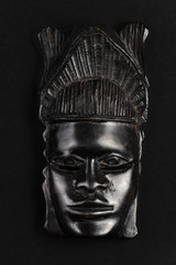 African mask souvenir isolated on a black background. Gift concept.