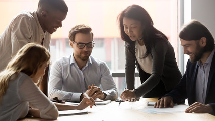 Employees with team leader working on new project at meeting