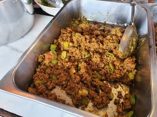 Ground pork stirred with curry paste and smelly beans. Red curry ground pork and Parkia speciosa (Sator) selling at local street market, bangkok, thailand.