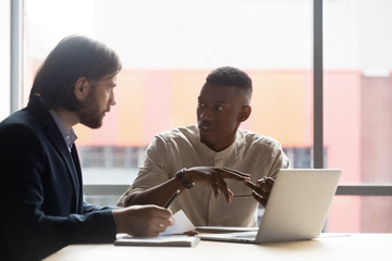 African American manager consulting client about insurance at meeting